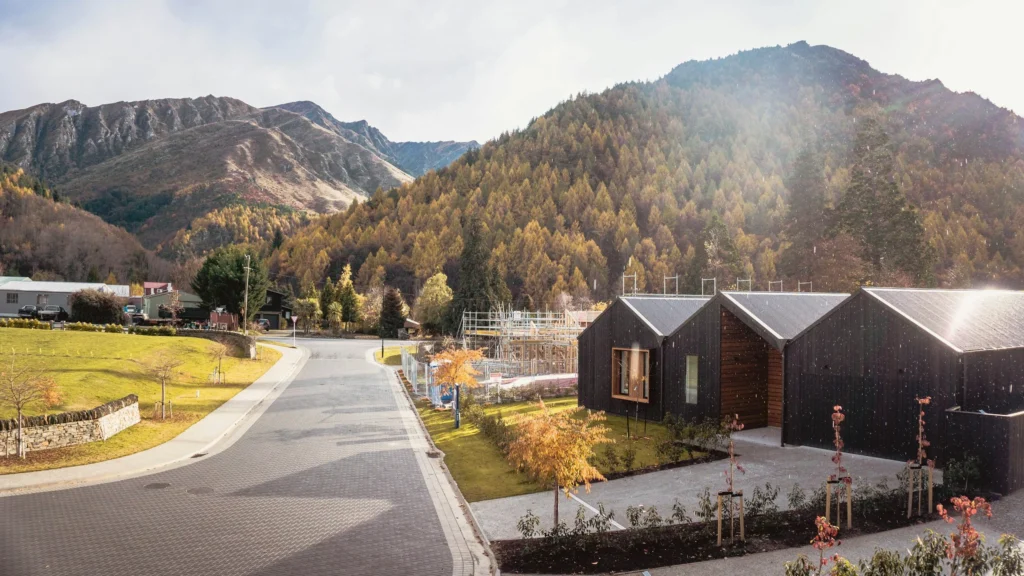 Nestled in Arthurs Point, this modern wooden house basks under a sunny sky, surrounded by a valley of autumn-colored trees and a majestic mountainous backdrop. A neighbourhood that wouldn't be possible without subdivision consent and land use consent